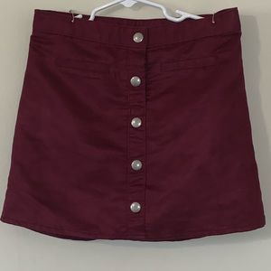 Girls deep red skirt.
